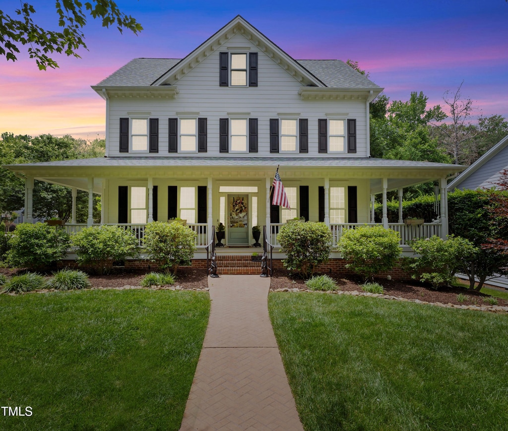 200 Cobblepoint Way, Holly Springs, NC 27540 - country-style home with roof with shingles, a porch, and a front lawn