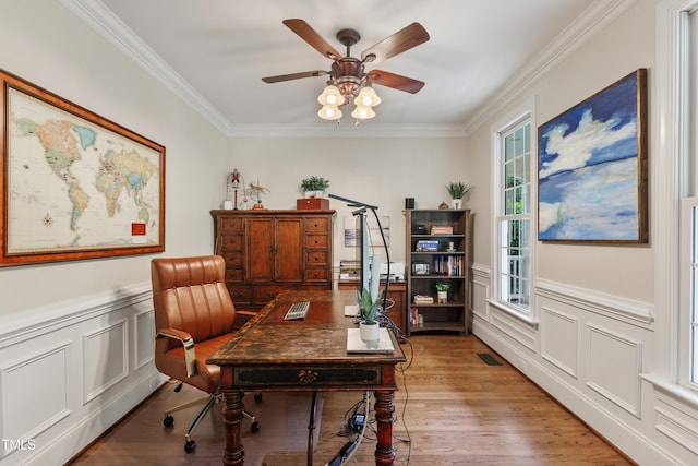 200 Cobblepoint Way, Holly Springs, NC 27540 - home office with ornamental molding, a ceiling fan, light wood-type flooring, wainscoting, and a decorative wall
