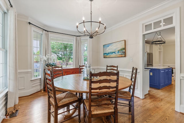 200 Cobblepoint Way, Holly Springs, NC 27540 - dining space featuring a chandelier, ornamental molding, light wood finished floors, a decorative wall, and a wainscoted wall