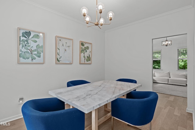3204 Plaza Pl, Raleigh, NC 27612 - dining space featuring a chandelier, crown molding, and wood finished floors