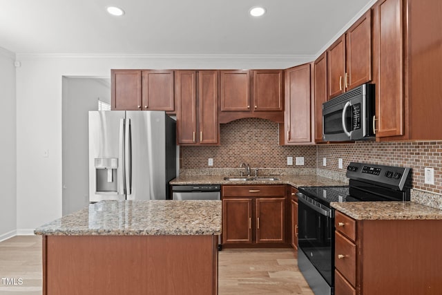 3204 Plaza Pl, Raleigh, NC 27612 - kitchen with appliances with stainless steel finishes, crown molding, light wood-style floors, light stone counters, and a kitchen island