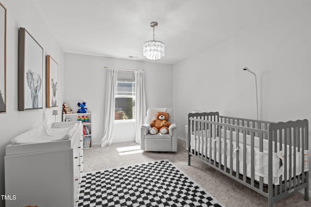 3204 Plaza Pl, Raleigh, NC 27612 - carpeted bedroom featuring a chandelier and a crib