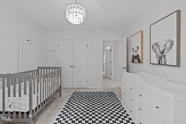 3204 Plaza Pl, Raleigh, NC 27612 - bedroom featuring a closet, a chandelier, light flooring, and a crib