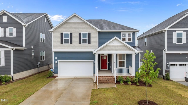 125 Shadowdale Ln, Rolesville, NC 27571 - view of front of home with covered porch, a garage, a front yard, and driveway