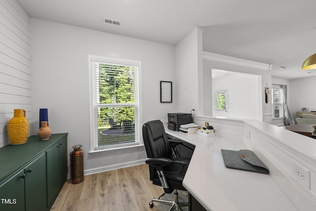 office area featuring light wood finished floors, healthy amount of natural light, and baseboards