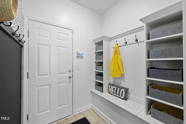 mudroom featuring light wood-style floors and baseboards