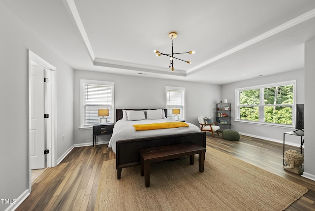 bedroom with a raised ceiling, a chandelier, wood finished floors, and baseboards