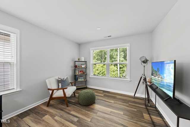 living area featuring wood finished floors and baseboards