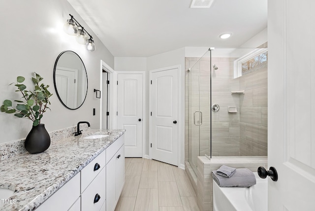full bath featuring a stall shower, vanity, and recessed lighting