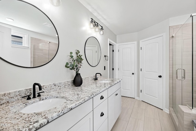 full bathroom with a stall shower and double vanity