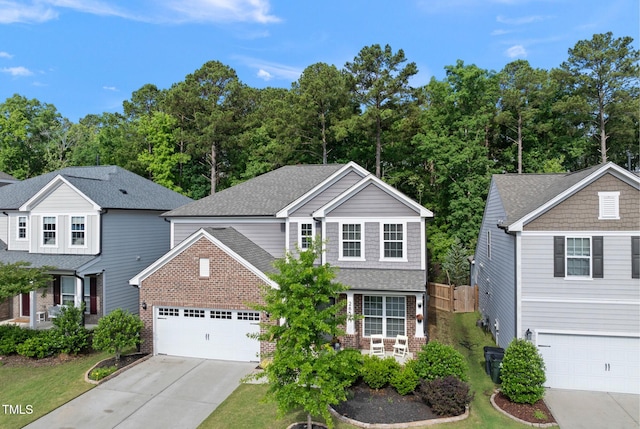 traditional home with brick siding, concrete driveway, a garage, a shingled roof, and fence