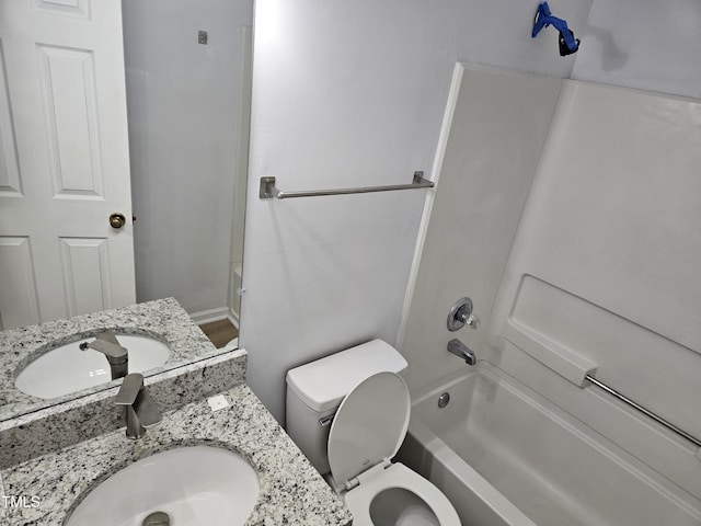 bathroom with vanity, toilet, and  shower combination