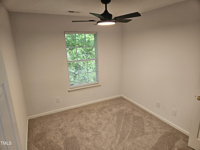 empty room with ceiling fan, carpet flooring, and baseboards