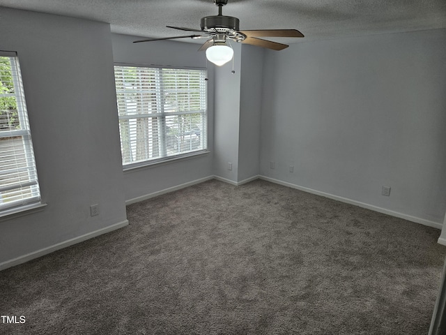 carpeted empty room featuring ceiling fan, a textured ceiling, and baseboards