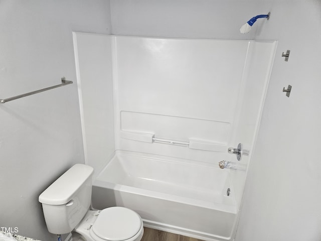 bathroom with toilet, shower / tub combination, and wood finished floors