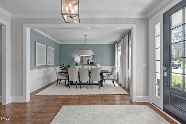 2711 Jordan Pointe Blvd, New Hill, NC 27562 - dining area featuring wood finished floors, a chandelier, ornamental molding, and wainscoting