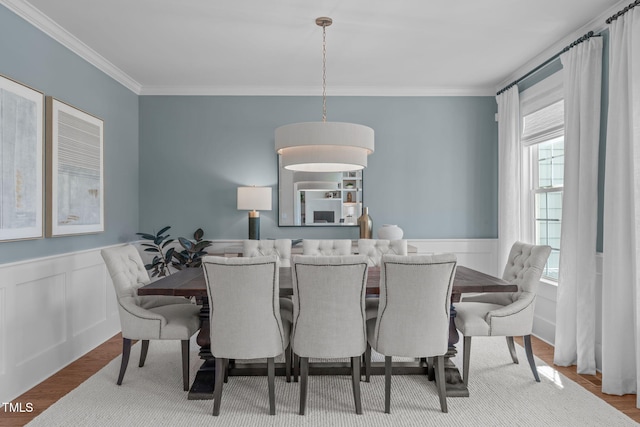 2711 Jordan Pointe Blvd, New Hill, NC 27562 - dining area with crown molding, a wainscoted wall, and wood finished floors