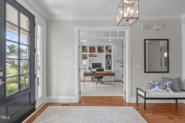 2711 Jordan Pointe Blvd, New Hill, NC 27562 - foyer with healthy amount of natural light, baseboards, wood finished floors, crown molding, and a chandelier