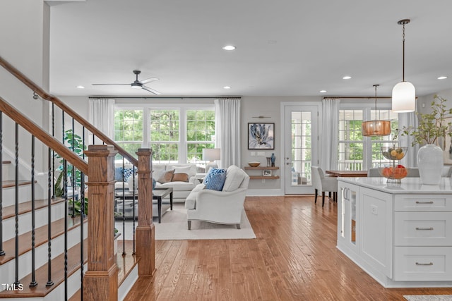 2711 Jordan Pointe Blvd, New Hill, NC 27562 - living room featuring stairway, light wood-style flooring, plenty of natural light, and recessed lighting