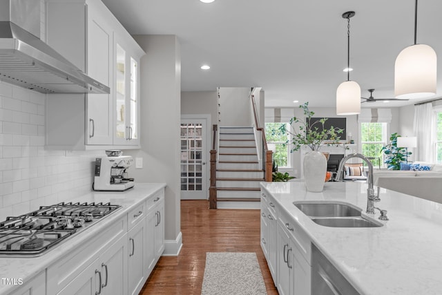 2711 Jordan Pointe Blvd, New Hill, NC 27562 - kitchen featuring wall chimney exhaust hood, a sink, appliances with stainless steel finishes, white cabinets, and glass insert cabinets