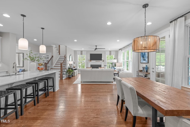 2711 Jordan Pointe Blvd, New Hill, NC 27562 - dining space with recessed lighting, stairs, ceiling fan, wood finished floors, and a fireplace