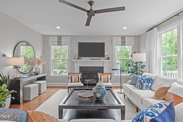 2711 Jordan Pointe Blvd, New Hill, NC 27562 - living room with healthy amount of natural light, baseboards, a fireplace with flush hearth, a ceiling fan, and recessed lighting