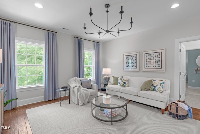 2711 Jordan Pointe Blvd, New Hill, NC 27562 - living room with baseboards, a chandelier, wood finished floors, and recessed lighting