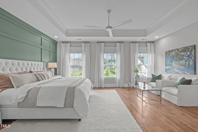 2711 Jordan Pointe Blvd, New Hill, NC 27562 - bedroom featuring a tray ceiling, crown molding, multiple windows, light wood-type flooring, and recessed lighting