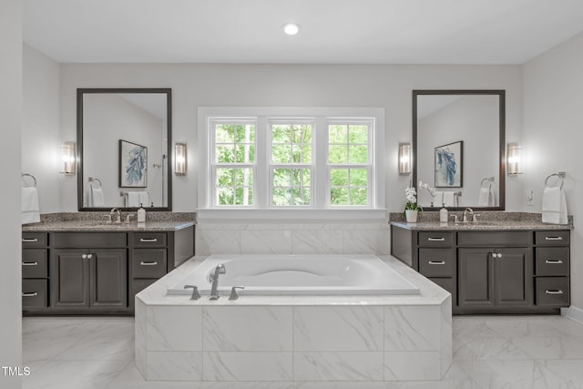 2711 Jordan Pointe Blvd, New Hill, NC 27562 - full bathroom with marble look tile flooring, two vanities, and a garden tub