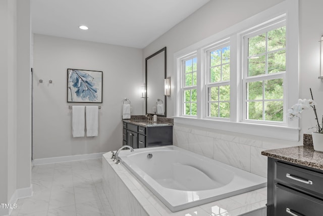 2711 Jordan Pointe Blvd, New Hill, NC 27562 - bathroom featuring vanity, marble finish flooring, baseboards, a garden tub, and recessed lighting