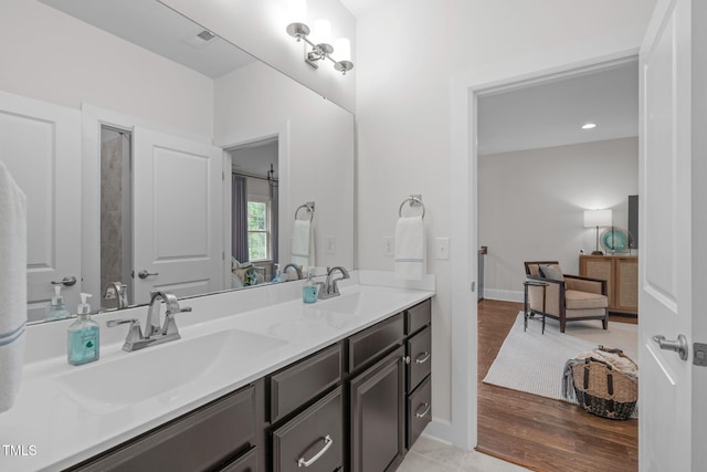 2711 Jordan Pointe Blvd, New Hill, NC 27562 - bathroom featuring double vanity, baseboards, and wood finished floors