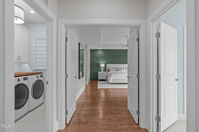 2711 Jordan Pointe Blvd, New Hill, NC 27562 - laundry room with washer and clothes dryer, cabinet space, wood finished floors, and baseboards