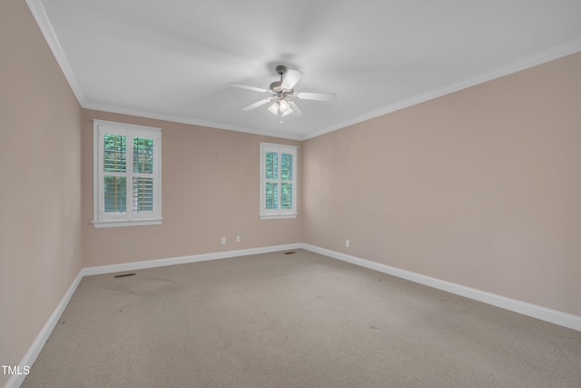 unfurnished room with a ceiling fan, baseboards, light colored carpet, healthy amount of natural light, and ornamental molding