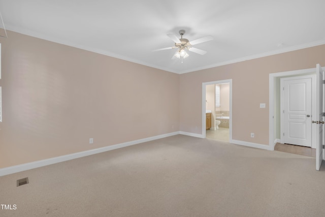 unfurnished bedroom featuring light colored carpet, baseboards, ornamental molding, connected bathroom, and a ceiling fan