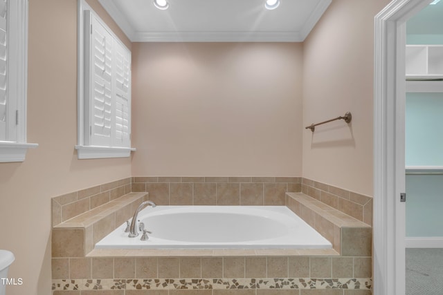 full bath with a bath, crown molding, and toilet