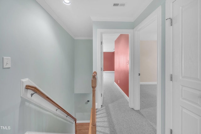 hall with an upstairs landing, baseboards, carpet, crown molding, and recessed lighting