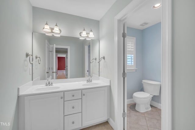 full bath featuring double vanity, tile patterned flooring, toilet, and baseboards