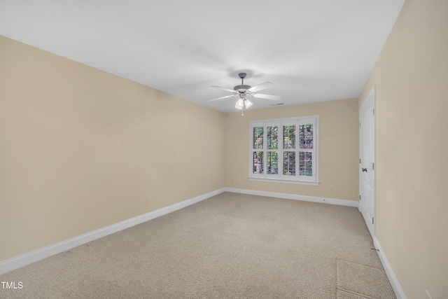 unfurnished room featuring a ceiling fan, baseboards, and light colored carpet