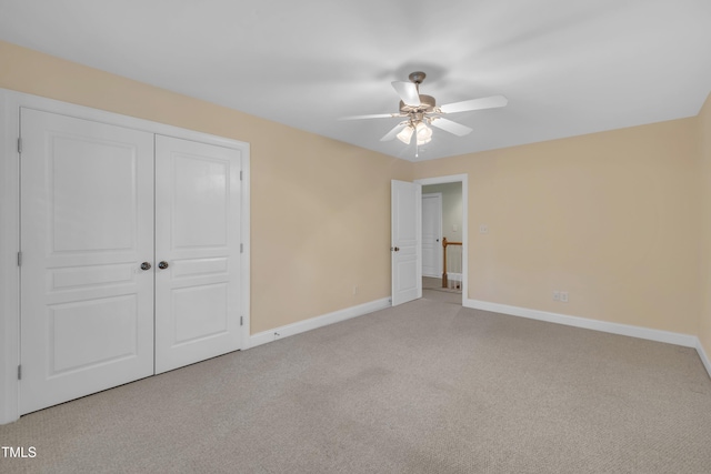 unfurnished bedroom with carpet, baseboards, a closet, and ceiling fan