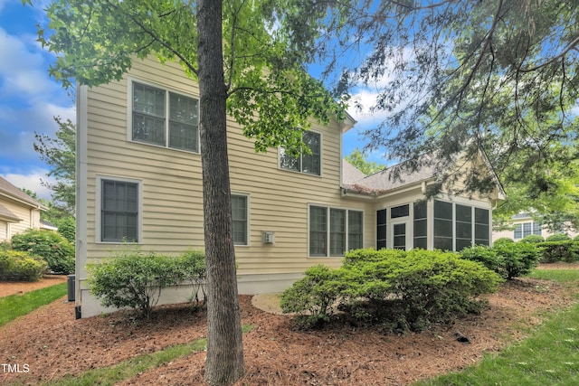 back of house featuring a sunroom