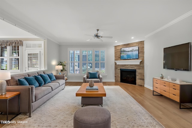 1608 Heritage Links Dr, Wake Forest, NC 27587 - living room with light wood-style floors, ceiling fan, a fireplace, recessed lighting, and ornamental molding