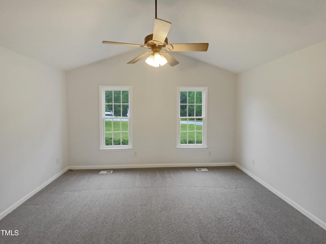 carpeted empty room with baseboards, ceiling fan, and vaulted ceiling