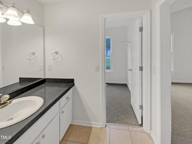 bathroom featuring baseboards and vanity