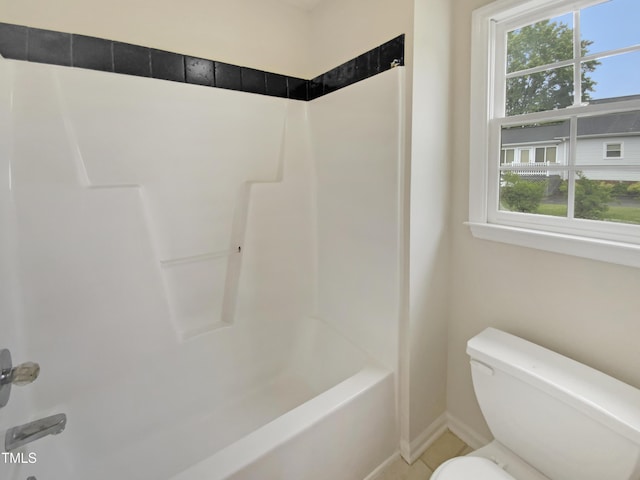bathroom with healthy amount of natural light, toilet, and shower / bath combination