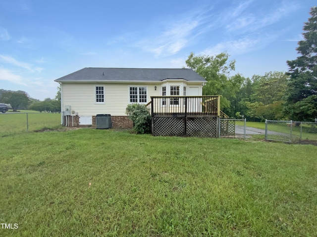 rear view of property with central AC, a wooden deck, and a garage