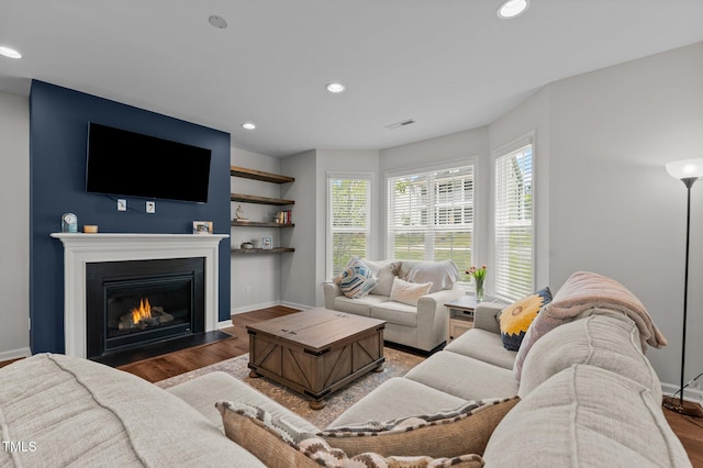 8925 Lee Brown Ridge Dr, Wake Forest, NC 27587 - living area featuring recessed lighting, wood finished floors, baseboards, and a glass covered fireplace