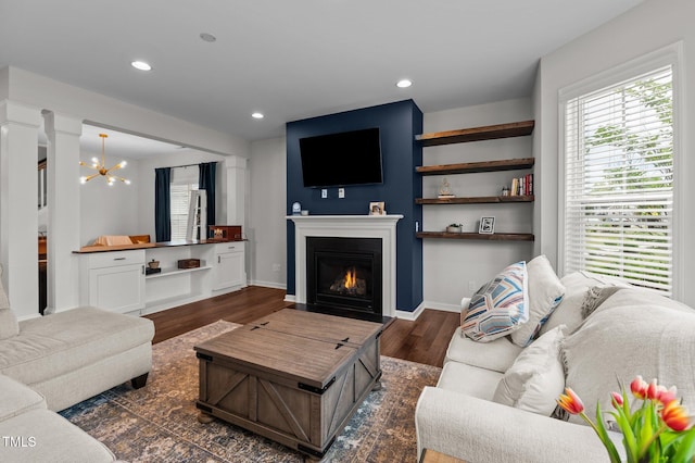 8925 Lee Brown Ridge Dr, Wake Forest, NC 27587 - living room with plenty of natural light, dark wood-style floors, a lit fireplace, a chandelier, and recessed lighting