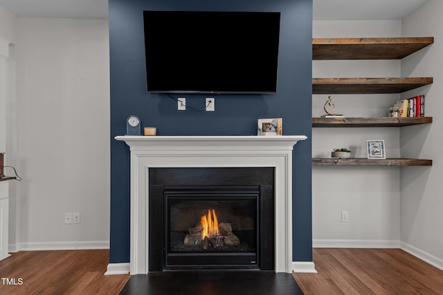 8925 Lee Brown Ridge Dr, Wake Forest, NC 27587 - detailed view of a warm lit fireplace, wood finished floors, and baseboards
