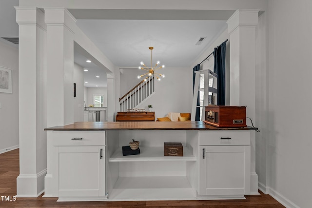 8925 Lee Brown Ridge Dr, Wake Forest, NC 27587 - kitchen with dark countertops, open shelves, white cabinetry, and recessed lighting
