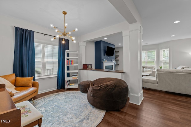 8925 Lee Brown Ridge Dr, Wake Forest, NC 27587 - living area featuring ornate columns, wood finished floors, a chandelier, baseboards, and recessed lighting